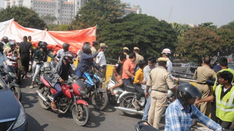 Spectator fractures leg as automotive crash reasons concrete block to fall